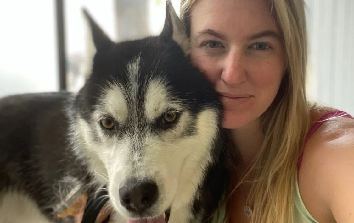Happy husky with the groomer at Premier Pet Services